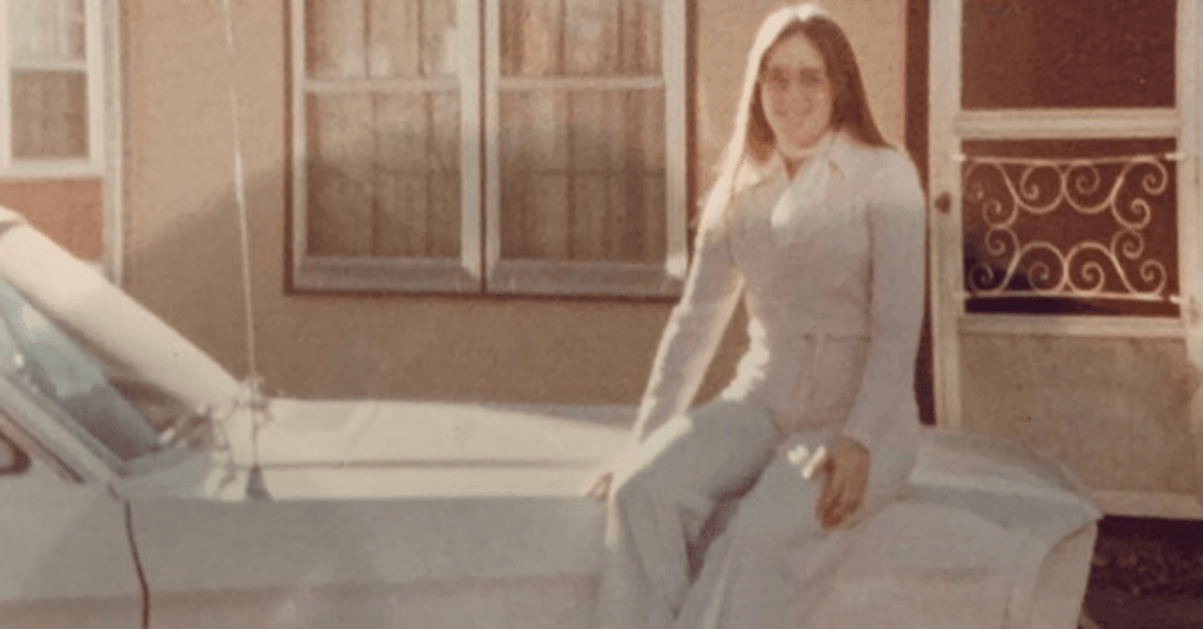 Catherine "Catrina" Mowrey sitting on the hood of a car